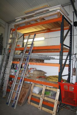 many shelves that have ladders in them in a garage