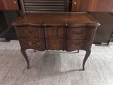 a wooden dresser with drawers on it in a room