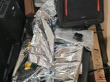 a pile of luggage and other items in a cardboard box