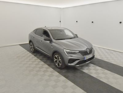 the grey car is parked in a white room with a black and white checkered floor