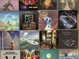 many different album covers on the wall of this room