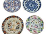 four plates with different designs and designs on them on a white background