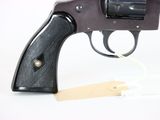 a gun that is sitting on a white surface