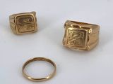two gold rings and a gold ring with a small gold ring on it