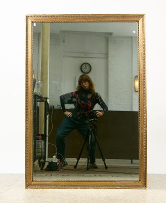 a woman taking a picture of herself in a mirror