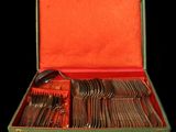 a green case with silverware in it on a black background