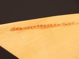 a close up of a piece of wood with writing on it