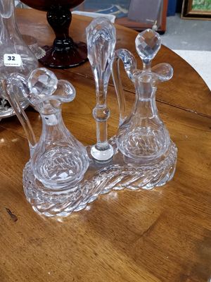 trois vases en verre posés sur une table, avec un vase à l'arrière-plan