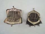 pair of silver purses with chain handles on a white surface