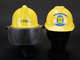 two yellow hard hats on a mannequin head on a black background