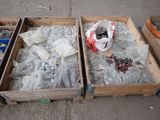 two wooden boxes filled with assorted items sitting on the ground
