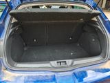 a trunk of a blue car with its doors open