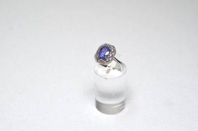 a close up of a ring with a tan sapphire and diamonds