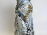 a blue and white vase sitting on a white surface