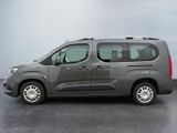 the grey van is parked in the parking lot on a cloudy day