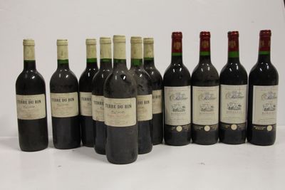 several bottles of wine are lined up in a row on a table