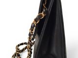 a close up of a black purse with a chain around it