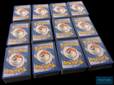 a lot of pokemon cards sitting on top of each other