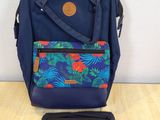 a close up of a blue backpack with a laptop on a table