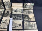 several old black and white photographs of buildings and buildings on a table