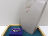 necklace, ring, and ring box on display in a display case