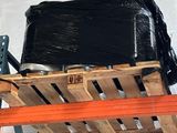 a black suitcase sitting on top of a pallet in a warehouse