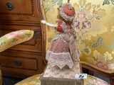 a doll that is sitting on a chair in a room