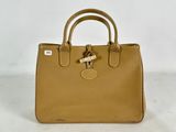 a tan leather handbag with a metal lock on the handle