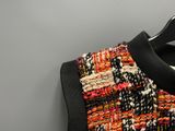 a close up of a sweater hanging on a hanger