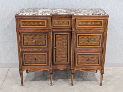 a wooden cabinet with a marble top and drawers