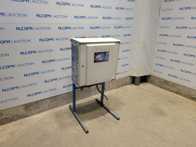 une photo d'une machine dans une pièce, avec une affiche accrochée au mur derrière elle