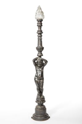 a silver statue of a boy holding a lamp post on a white background