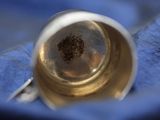 a close up view of a brass bell on a blue cloth