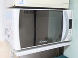 a microwave that is sitting on top of a shelf