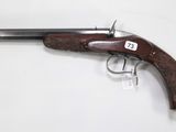 a close up of a gun on a table with a white background