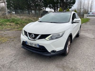 the white nissan qx - v is parked on the side of the road