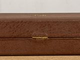 a brown suitcase sitting on top of a wooden table