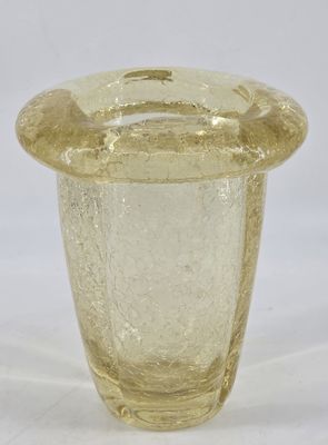 a glass vase with a lid on a white surface