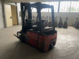 a red fork truck parked in a large warehouse