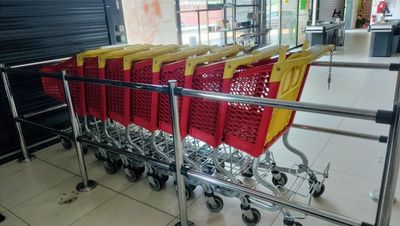 many shopping carts that are lined up in the store