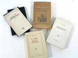 several books are sitting on a white surface with a white background