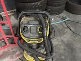 yellow and black wet dryer sitting on top of a pile of tires