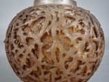 a glass vase with a pattern on it on a table
