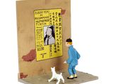 a figurine of a man and a dog in front of a poster