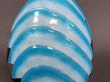 a blue and white vase sitting on a table