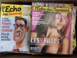 two magazines in a cardboard box on a table