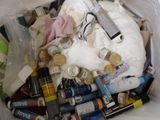 a white trash bag filled with various items in it