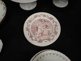 many plates and bowls on a table with a picture on them