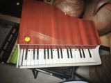 a book that is sitting on top of a piano keyboard
