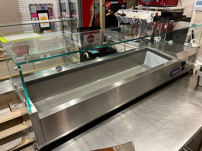 a counter with a glass display case in the middle of it